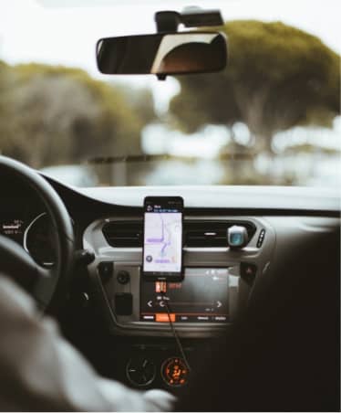 Rideshare driver with navigation attached to car dashboard