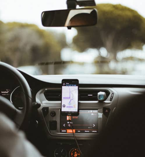 Rideshare driver with navigation attached to car dashboard